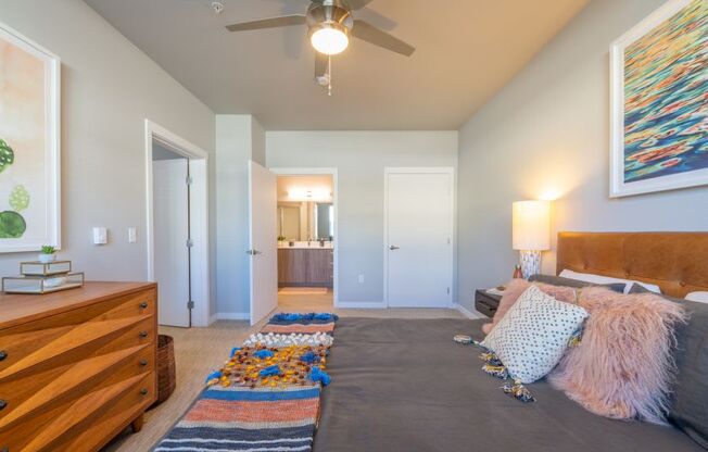 a bedroom with a bed and a ceiling fan