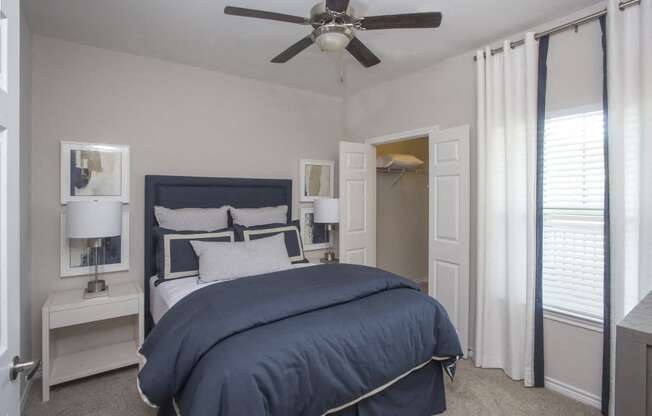 a bedroom with a bed and a ceiling fan