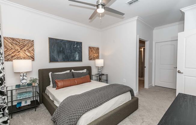 a bedroom with a bed and a ceiling fan