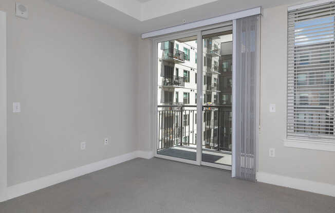 Carpeted Bedroom with Balcony