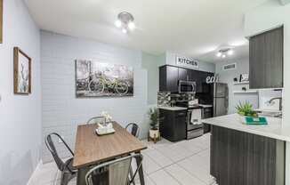 an open kitchen and dining room with a table and chairs