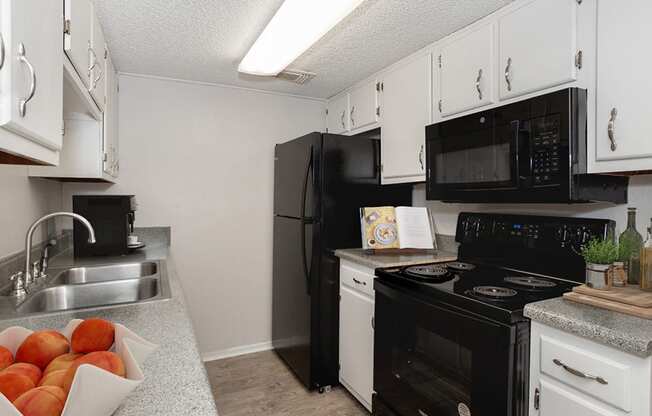 apartment with black kitchen appliances