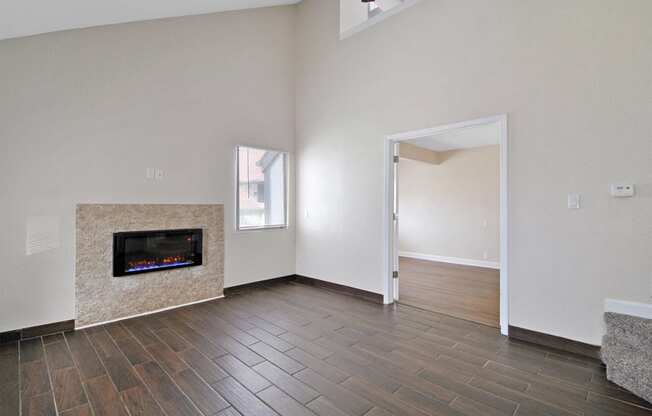 the living room has a fireplace and hardwood floors