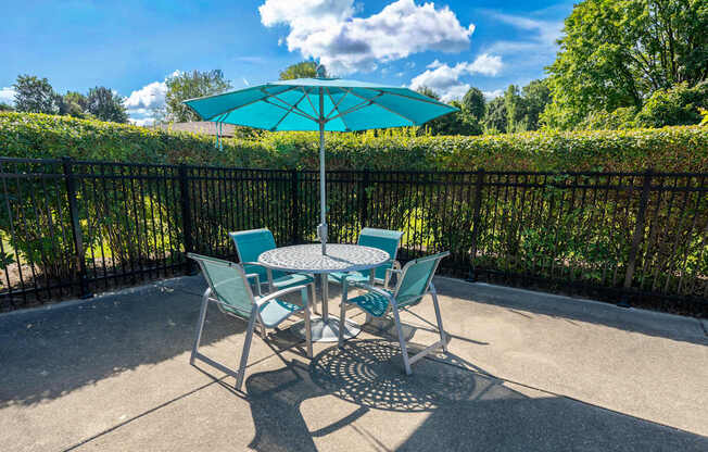 Umbrella and Chairs on Sundeck at Westwood Village Apartments in Westland
