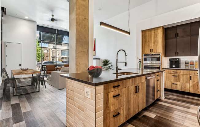 a kitchen with wooden cabinets and a large island with a sink