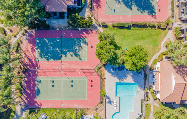 a property with a tennis court and a pool on the ground