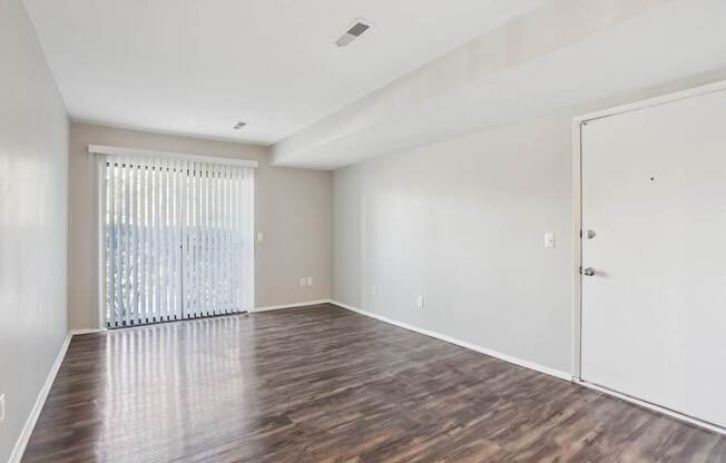 A room with wooden floors and a white door.
