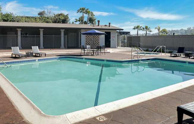 A swimming pool with a table and chairs.