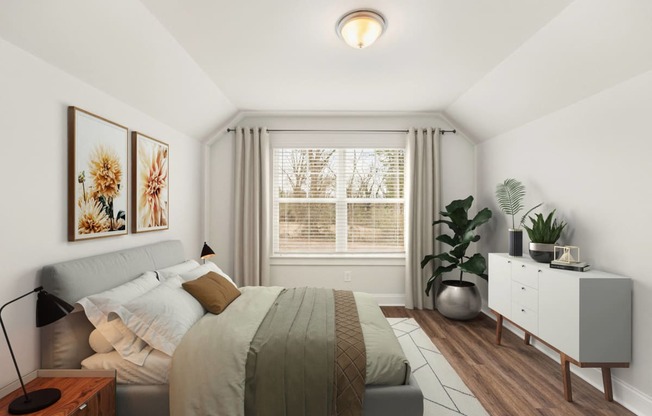 a bedroom with a bed and a large window