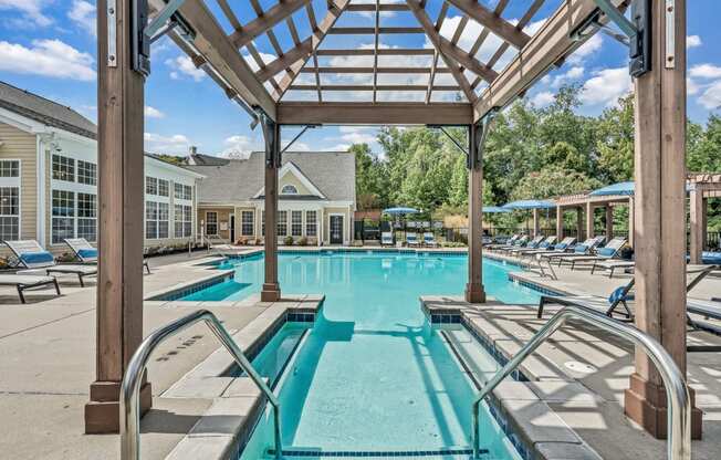 the resort style pool is surrounded by lounge chairs