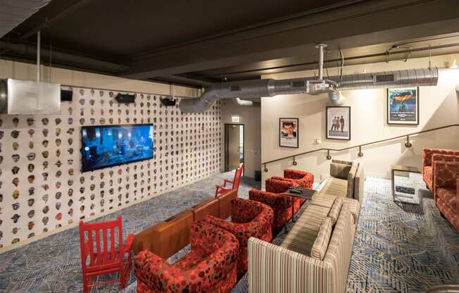 a living room with couches and chairs and a television on the wall