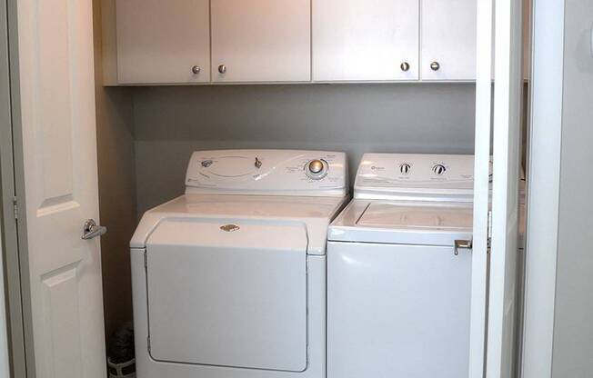 Side-by side white washer and dryer at Residences at Forest Park, Missouri