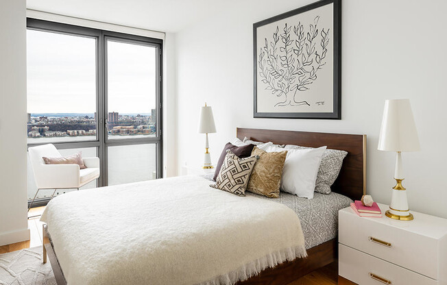 Floor to ceiling windows in two-bed apartment in Hell's Kitchen with hardwood floors and in unit was