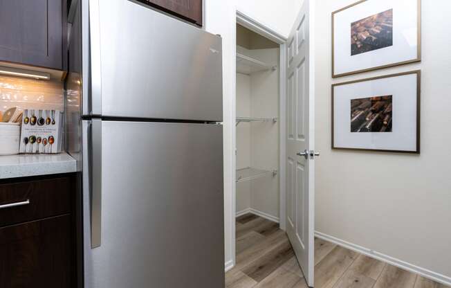 a kitchen with a refrigerator and a walk in closet