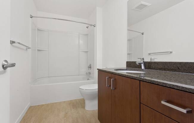 a bathroom with a sink and a toilet and a shower