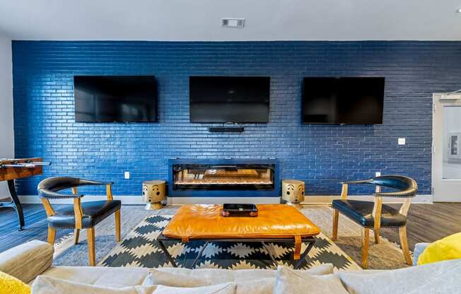 a living room with a blue brick wall and a fireplace