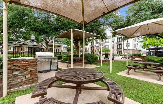 A patio with a table and chairs under a canopy.
