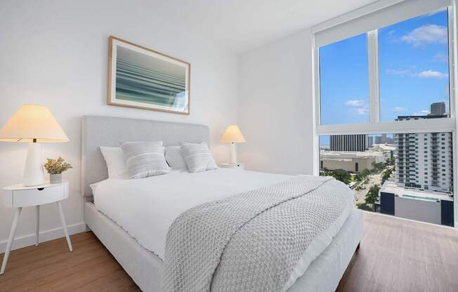 a bedroom with a bed and a large window