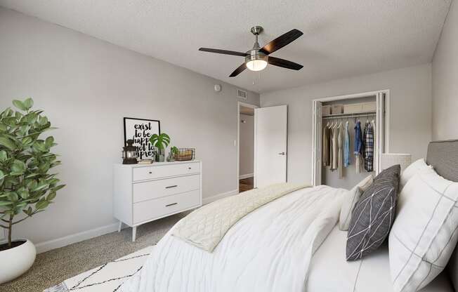 a bedroom with a large bed and a ceiling fan