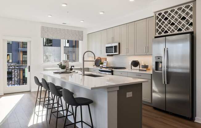 a kitchen with a large island and stainless steel appliances