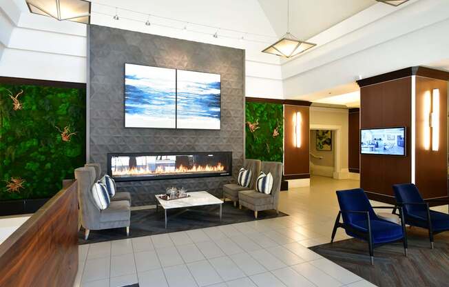 A living room with a fireplace and a TV on the wall.