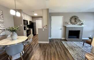 an open living room and dining room with a fireplace and a table