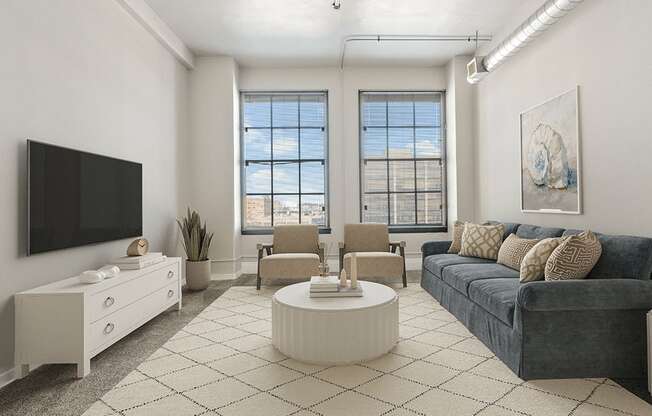 A living room with a grey couch, a white coffee table, a white dresser, a white TV and a large window.