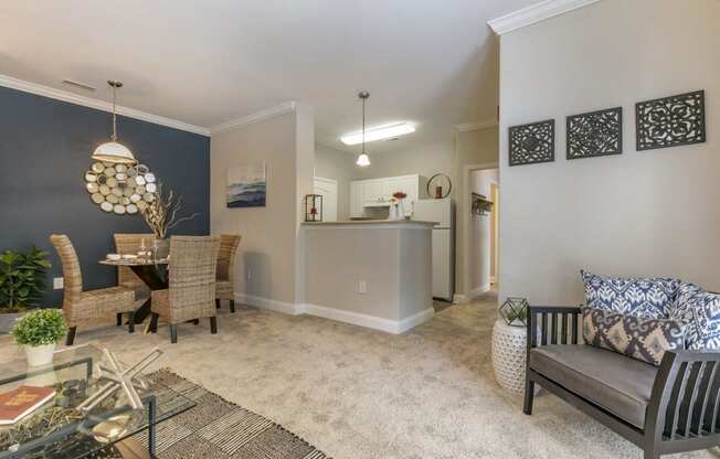 a living room and dining room with a table and chairs