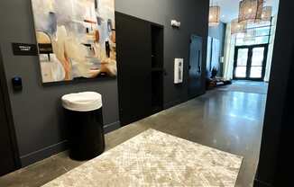 a hallway with a painting on the wall and a rug on the floor