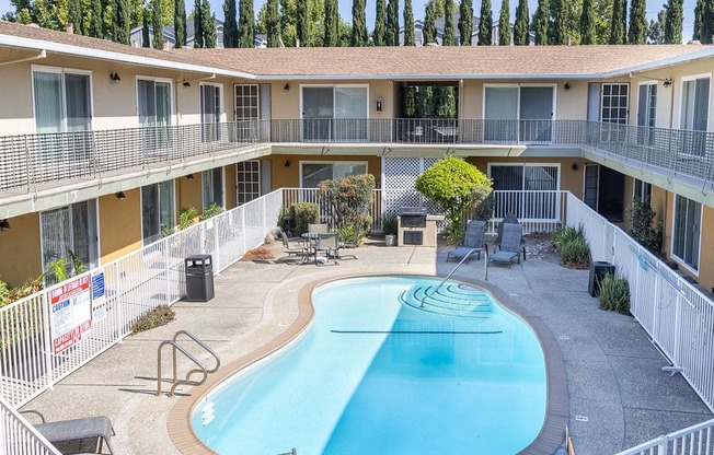 a building with a swimming pool in front of a hotel