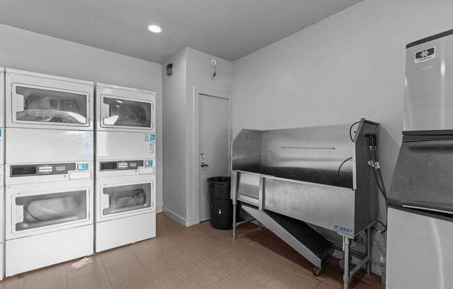 a kitchen with appliances and a bed and a refrigerator