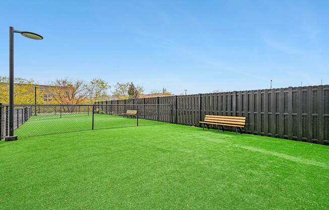 a yard with a tennis court and benches