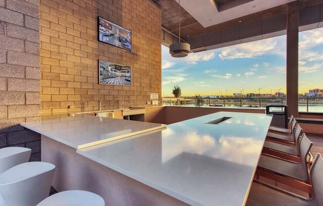 A bar with a view of the city at sunset.