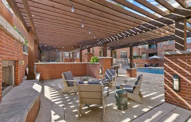 A patio with a table and chairs under a wooden pergola at Prairie Crossing, Texas 75244