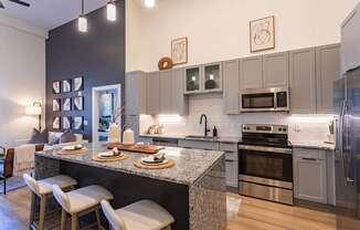 an open kitchen and dining room with stainless steel appliances