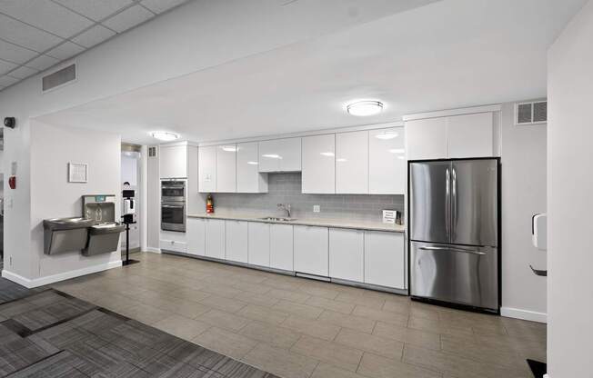 A modern kitchen with a refrigerator on the right side.