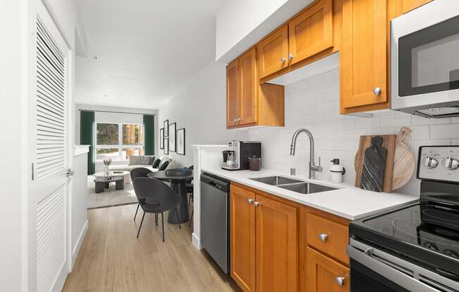 A kitchen with wooden cabinets and a black stove top oven.