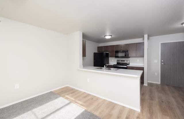 A kitchen area with a countertop and cabinets.