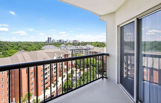 A balcony with a view of a city skyline.