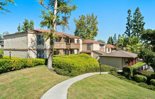 a sidewalk in front of a row of houses