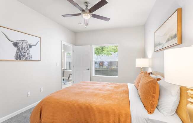 a bedroom with a bed and a ceiling fan