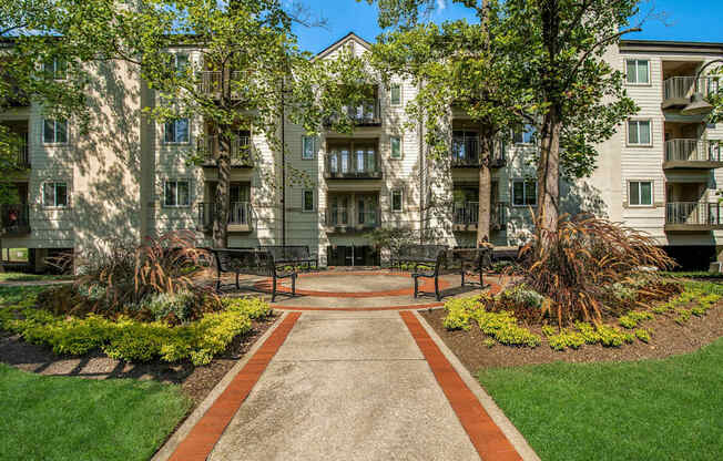 A pathway leads to a building with a green lawn on either side.