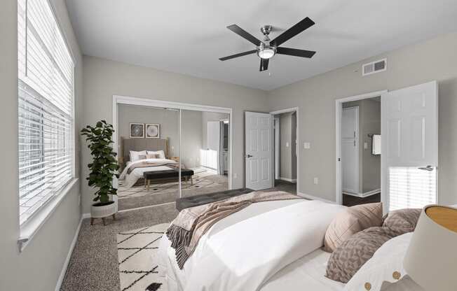 a bedroom with a large bed and a ceiling fan