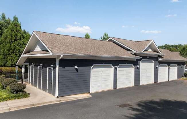 A building with a brown roof and white garage doors.