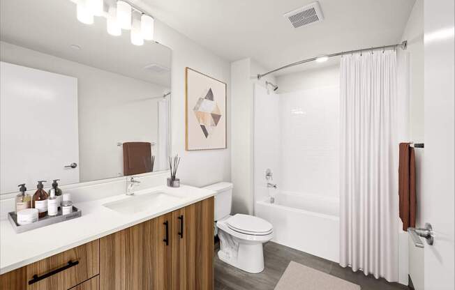 A bathroom with a white sink, toilet, and bathtub.