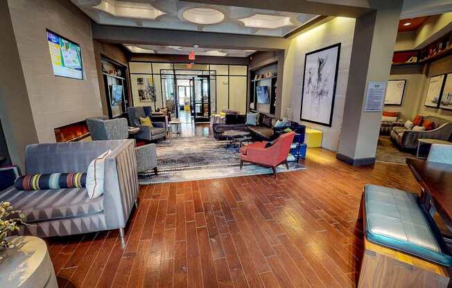 A living room with a grey couch and a red chair.