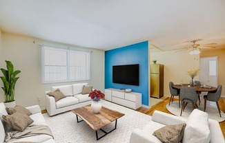 a living room with a blue accent wall and a white couch
