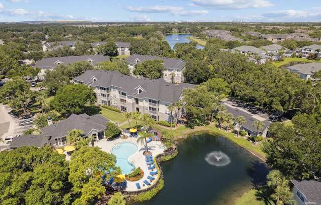 A bird's eye view of a resort with a swimming pool and a fountain.