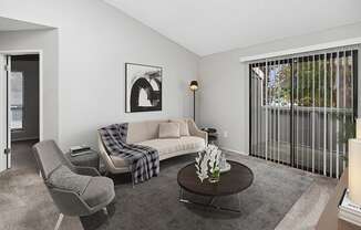 Model Living Room with Carpet and Patio Accessibility at The Meritage Apartments in Vallejo, CA.