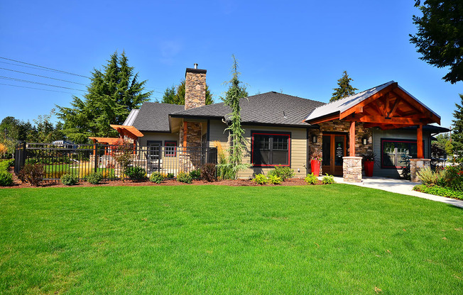 a home with green grass and a blue sky